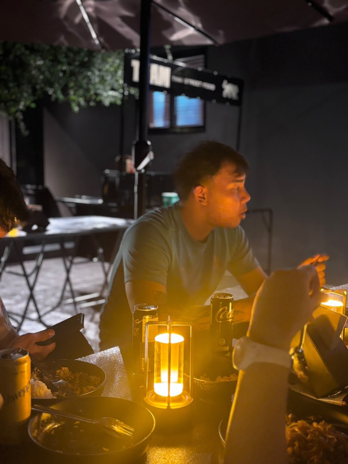 A diner at a softly lit table at THAM in Bangkok