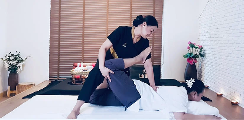 Loft Thai therapist performing a clothed traditional Thai massage stretch