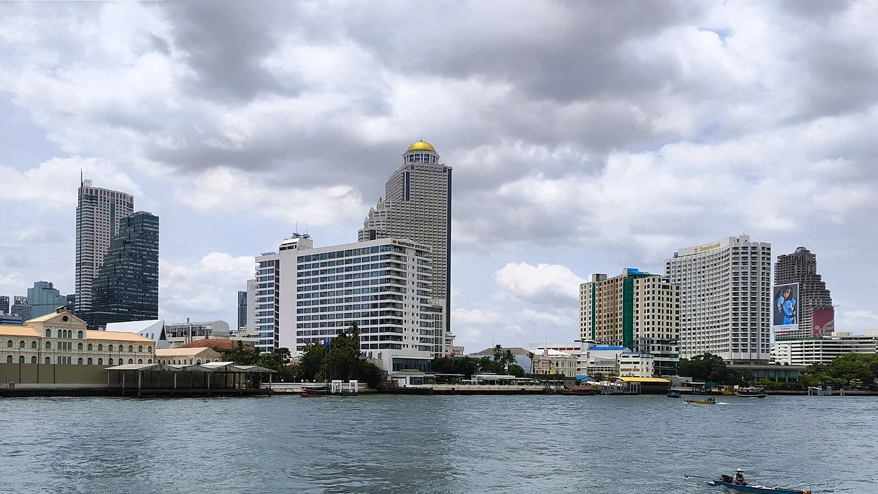 Bangkok riverside skyline and boats on the Chao Phraya River