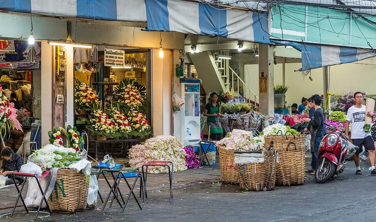 Flower sellers, baskets of garlands and colourful floral arrangements at Pak Khlong Talat in Bangkok