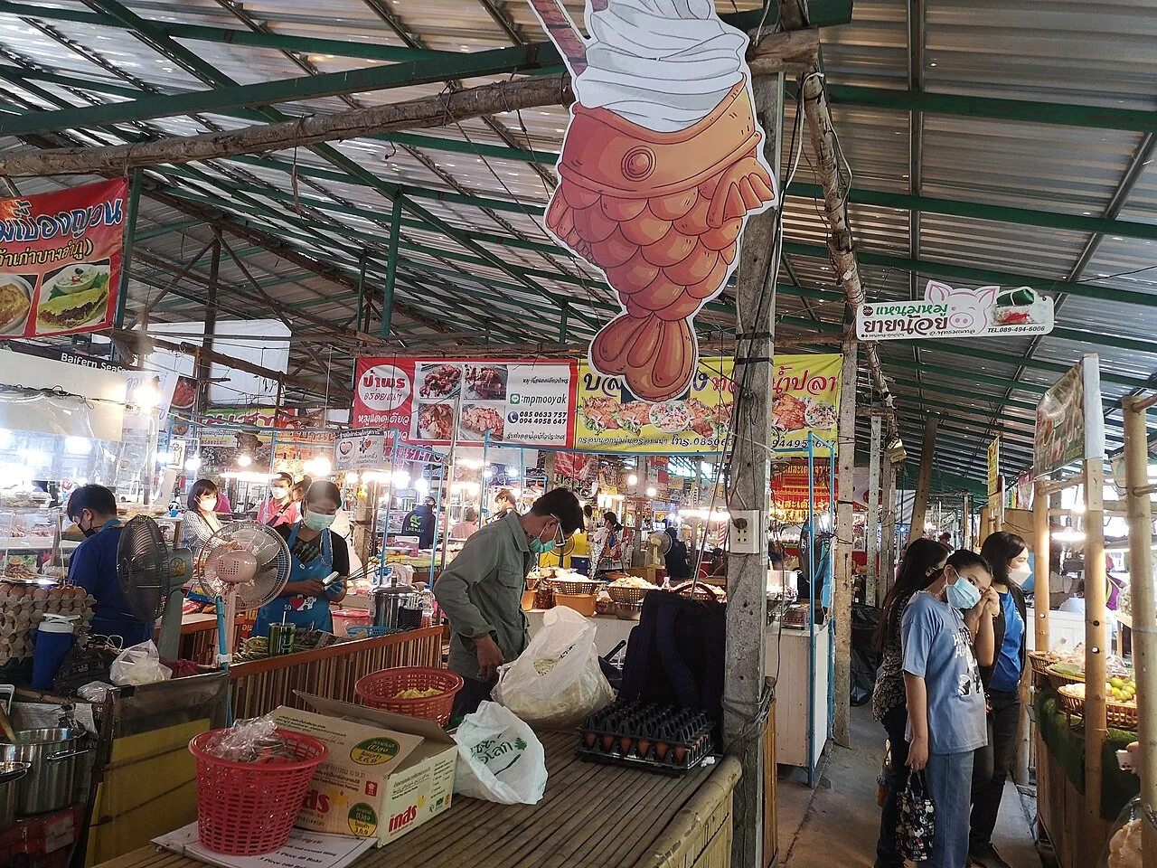 Food counters and shoppers under the roof of Khlong Lat Mayom Floating Market in Bangkok