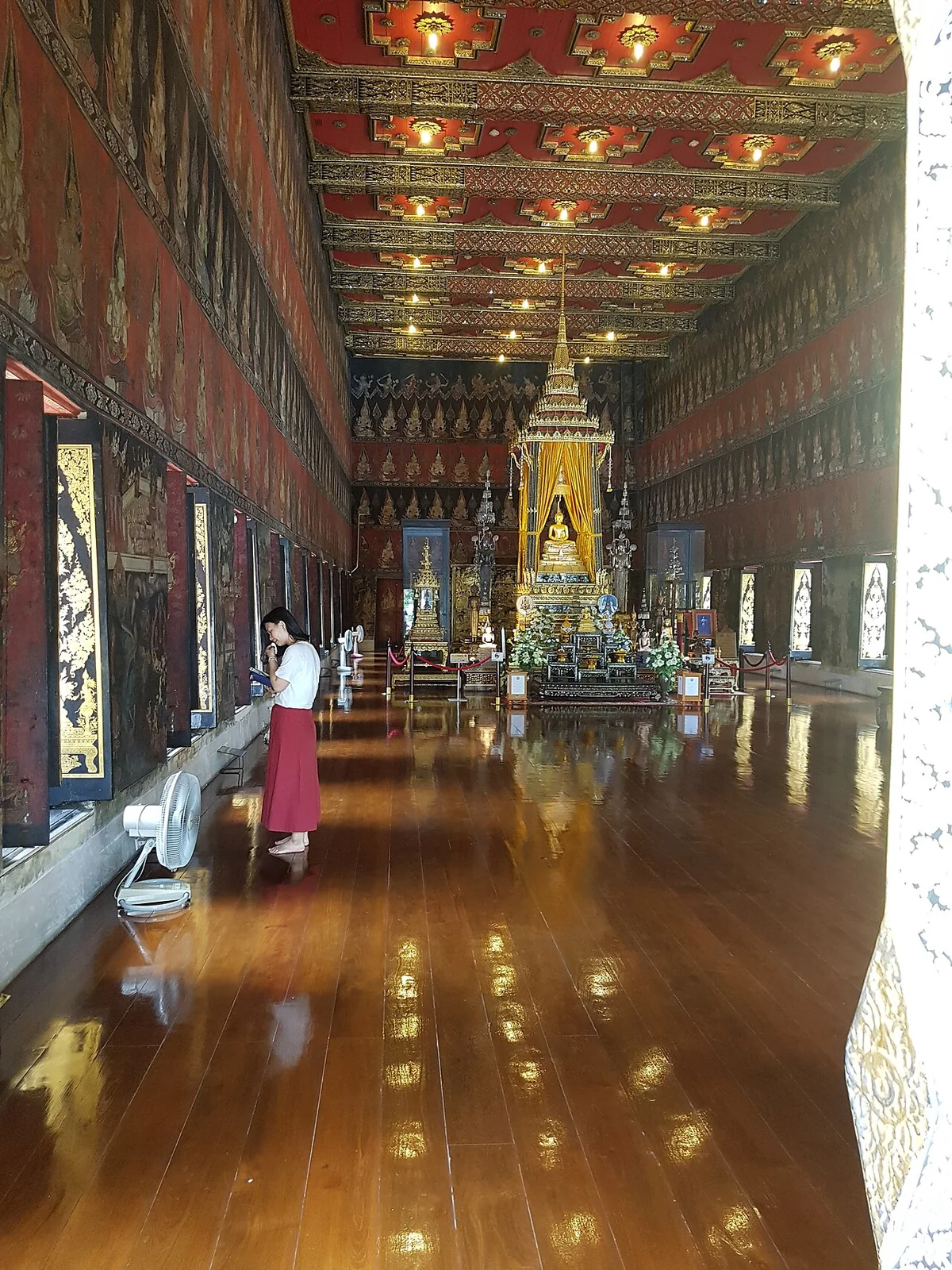 Golden Buddha shrine, mural walls and decorated ceiling inside Phutthaisawan Hall at Bangkok National Museum