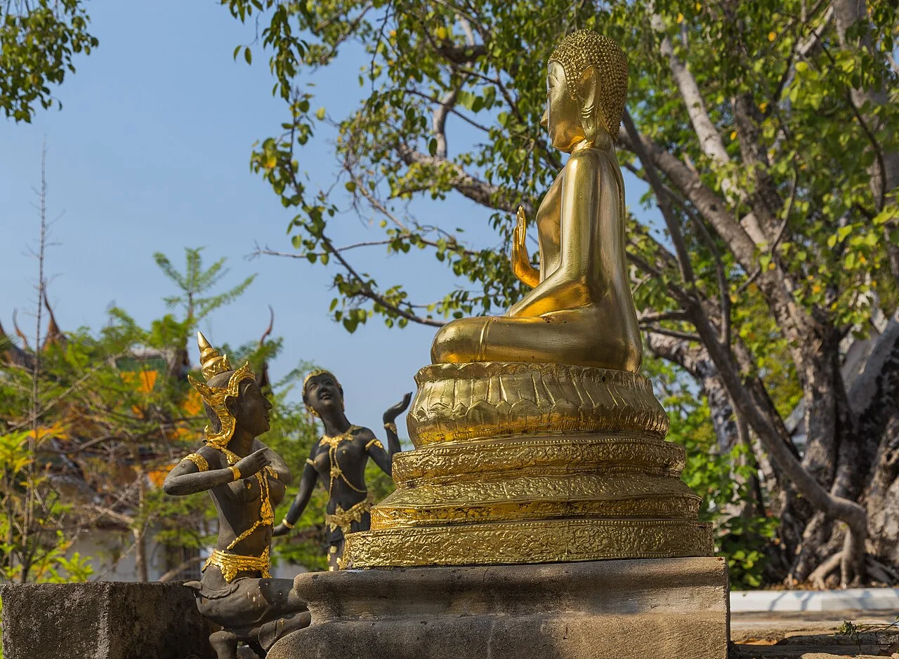 Golden Buddha and surrounding sculptures in the grounds of Wat Suthat in Bangkok